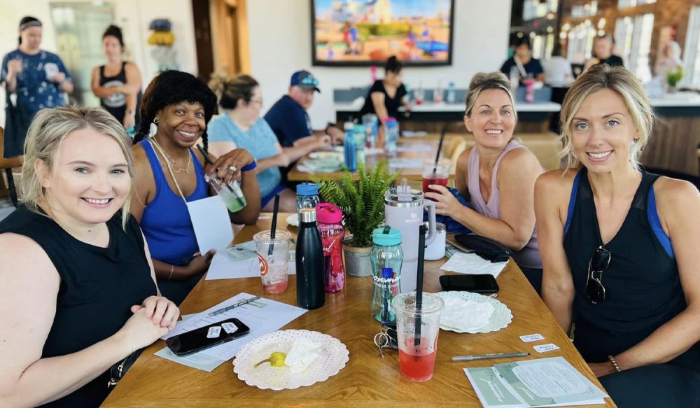group of 4 women relaxing after yoga
