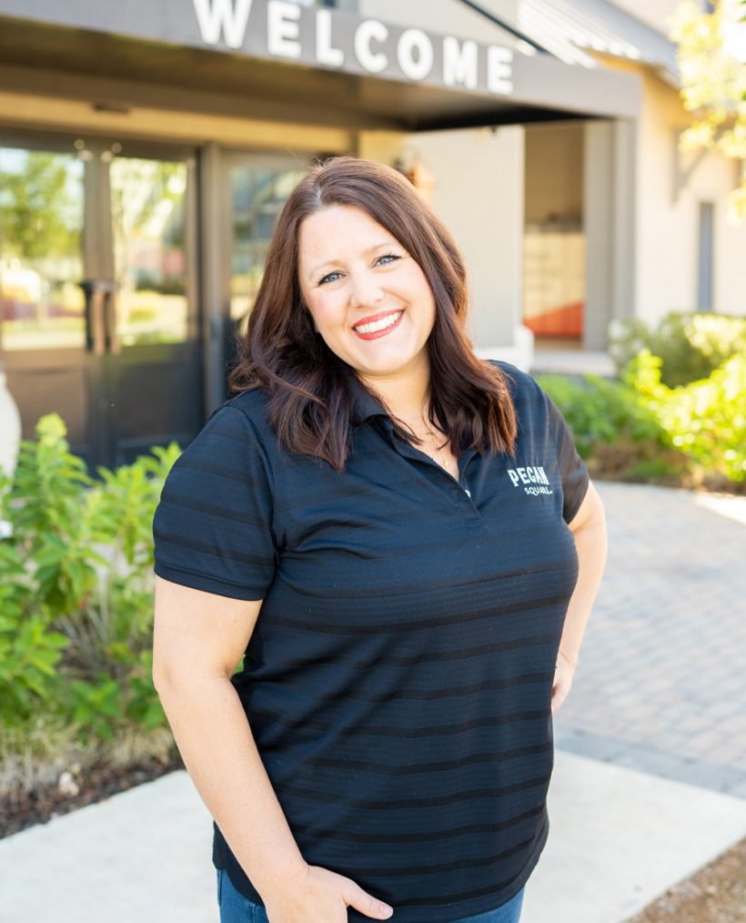Lifestyle Director Candice Culver standing in front of welcome sign