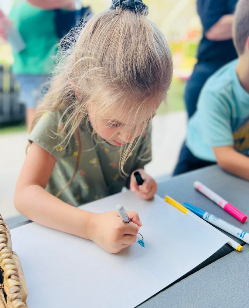 little girl concentrating on her drawing